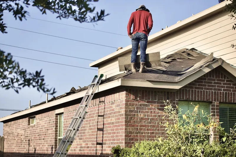 Professional roofer working on a residential roof in North Brentwood